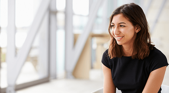 Young professional smiling while seated in a modern office environment 